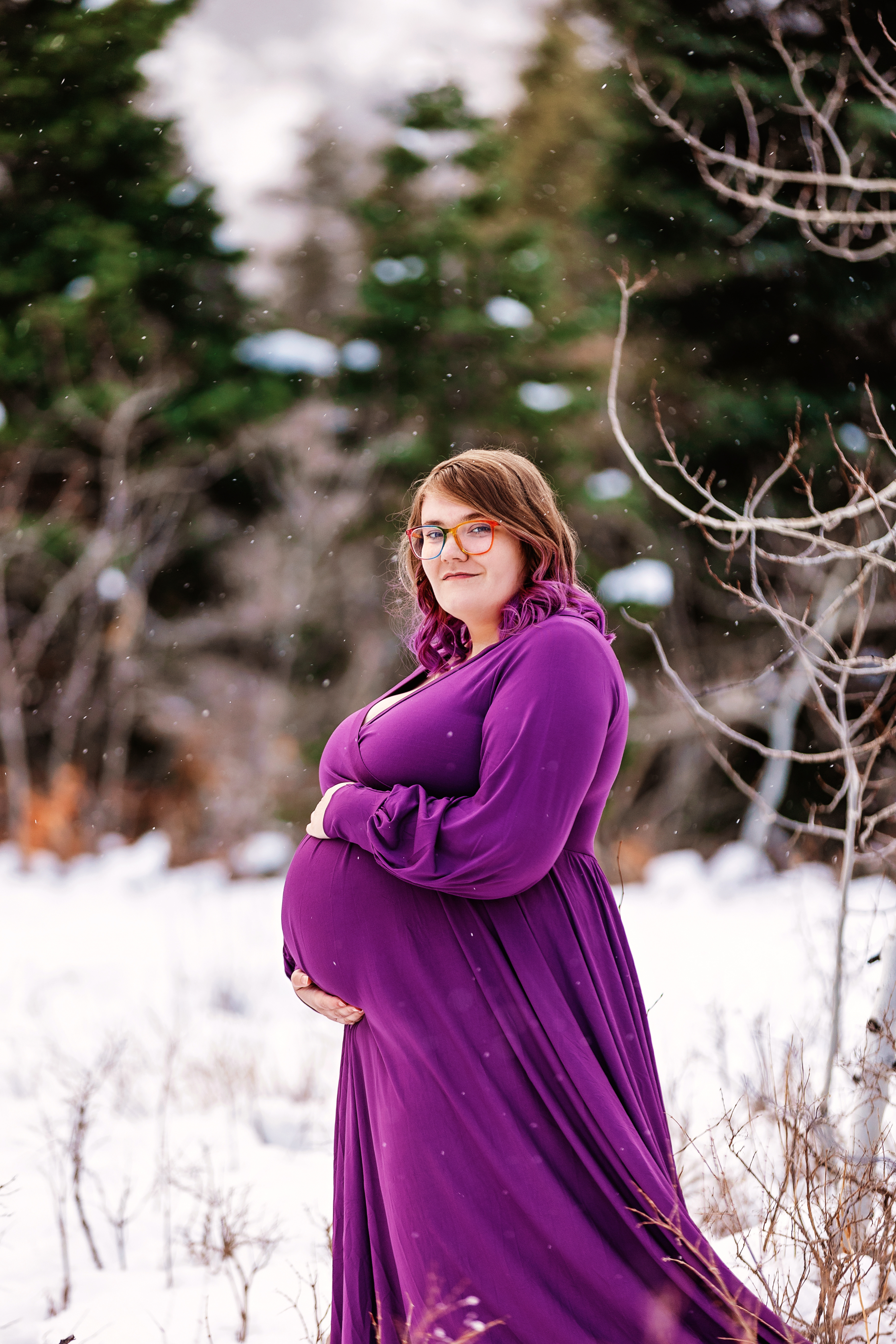 headshot of savannah. wearing purple and rainbow glasses.